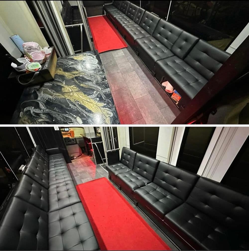 Luxurious black leather seating with red carpet in modern lounge interior.